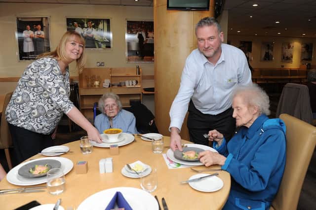 Donna Wilmshurst, director of curriculum at Havant and South Downs College and deputy principal, Richard Barlow, serve food to Joyce Mountain, 89 and Margaret Greasley, 77. Picture: Habibur Rahman