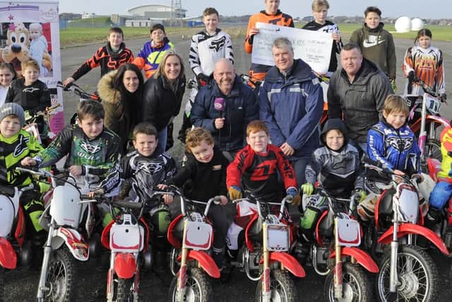 The Tigers children's motorcycle display team have donated over 3000 of its display show earnings to local charities (l to r), Stephanie Stares of The Tigers, Caroline Dinenage MP, Wave Fm's Andy Jackson, Councillor Sean Woodward of Hampshire County Council, and Justin Short of The Tigers.