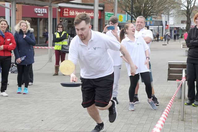 Danny Randon tossing his pancake during the race.