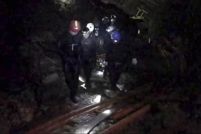 Rescuers hold an evacuated boy inside the Tham Luang Nang Non cave in Mae Sai, Chiang Rai province, in northern Thailand on July 11 last year 
Picture: Thai NavySEAL Facebook Page via AP