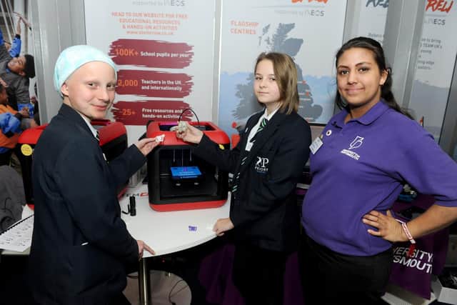 Freya Hawkes, 12, left, and Talula Goldring, 11, from The Priory School with Chloe Healy, student ambassador for the technology department at the University of Portsmouth, with one of the 3D printers.
Picture: Sarah Standing (080319-1414)