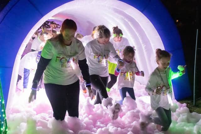 Participants emerge from the foam tunnel. Picture: Keith Woodland (090319-89)