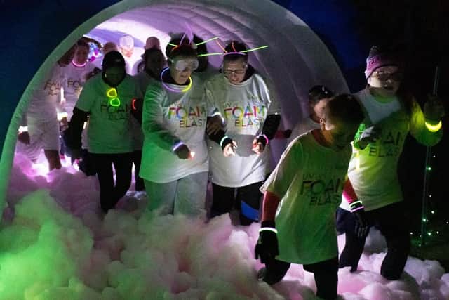 Pictured is: Participants emerge from the foam tunnel. Picture: Keith Woodland (090319-86)
