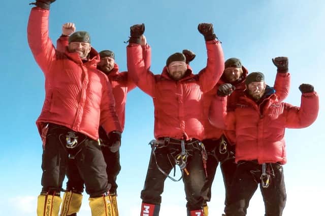 Joe, pictured right, with fellow Royal Marines on a climb.