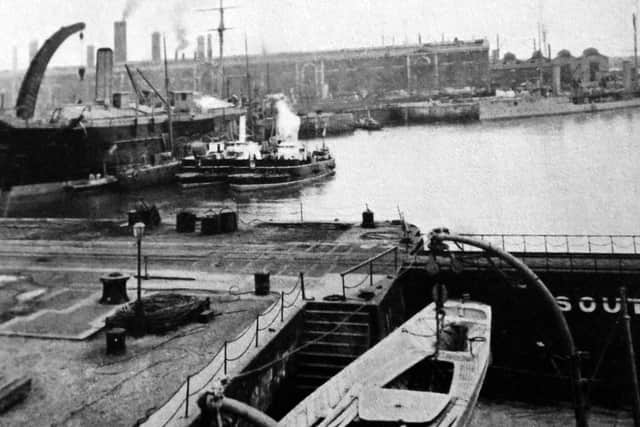The caption on this postcard tells us it is a tidal basin in Portsmouth dockyard. Photo: George Millener collection.