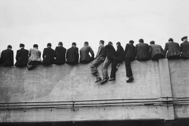 Precarious spectators watching Arsenal's opening game of the season against Portsmouth at the North London club's Highbury Stadium, 27th August 1938 (Photo by H. F. Davis/Topical Press Agency/Getty Images)