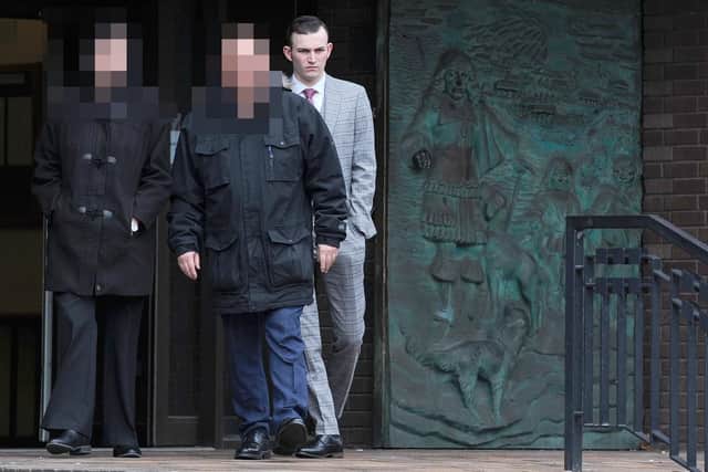 Royal Navy rating Kyle Catmull, 21, leaving Portsmouth Crown Court with his parents on Thursday, March 14, after dodging jail for attempting to meet a 15-year-old girl. Picture: (140319-2619)