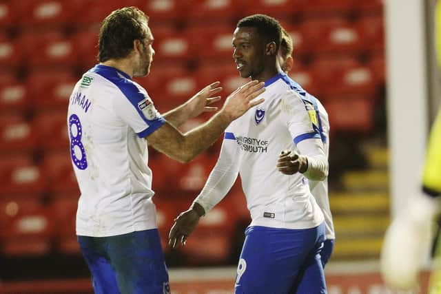 Viv Solomon-Otabor, right, celebrates his first goal for Pompey against Walsall with Brett Pitman. Picture: Joe Pepler