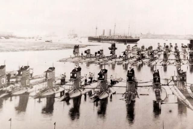 A gaggle of 33-submarines tied up at HMS Dolphin, Gosport pre-January 1922 as HMS Victory can be seen up harbour.