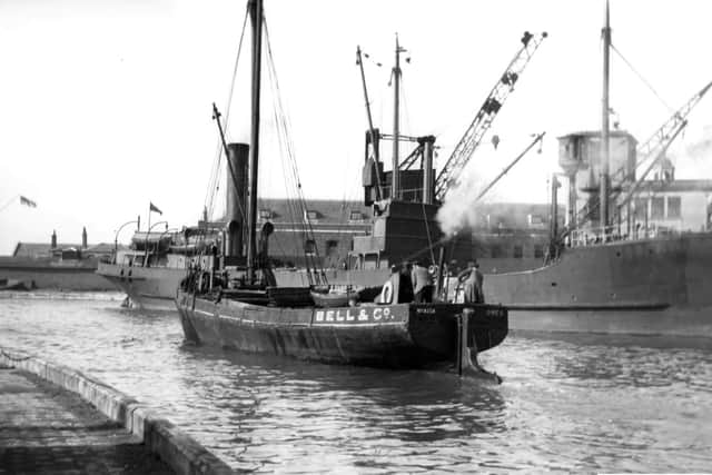 Scene at the Camber, Old Portsmouth. With a collier tied up alongside the Camber dock, we see a steam vessel making her way out to the harbour. Picture: Barry Cox collection.