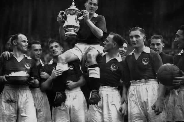 5th June 1939:  Jimmy Guthrie, the Portsmouth captain, being carried by his team mates after winning the FA Cup final.  (Photo by Keystone/Getty Images)