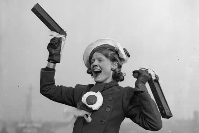 28th April 1934:  A Portsmouth football fan with a rattle in each hand cheering for her team before their FA Cup final against Manchester City, which the latter won 2-1.  (Photo by Fox Photos/Getty Images)