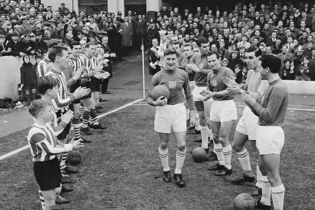 Soccer players from Southampton FC and Portsmouth FC enter the field before a match, UK, 16th January 1965. (Photo by Daily Express/Hulton Archive/Getty Images)
