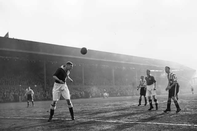 24th February 1939:  T Rowe, the Portsmouth FC centre-half heads the ball during a match against Brentford.  (Photo by H. F. Davis/Topical Press Agency/Getty Images)