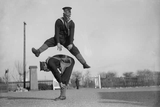 22nd January 1934:  Able seamen at the Royal Navy Anti-Gas School at Tipner, Portsmouth play leapfrog wearing gas masks, to accustom them to carrying out strenuous tasks in respirators.  (Photo by William Vanderson/Fox Photos/Getty Images)