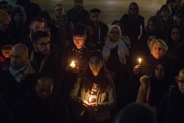 People gather for a minute's silence at the vigil for Christchurch, New Zealand, held at Portsmouth Guildhall on Monday night. Picture: Habibur Rahman