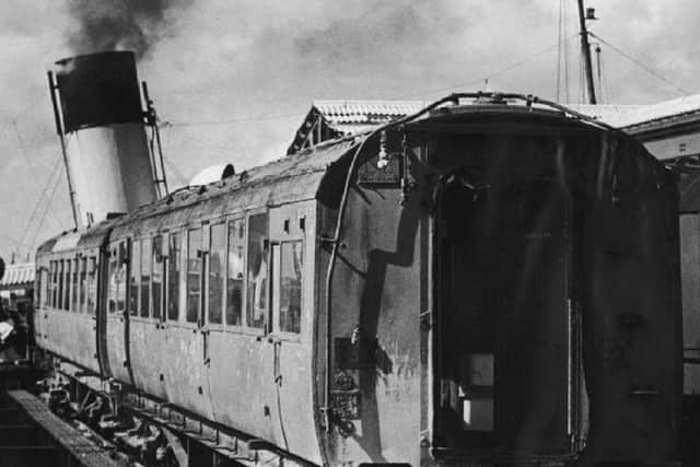 During the air raid of January 10, 1941 these two coaches fell into the mud at Portsmouth Harbour. Picture:  T Bye collection.