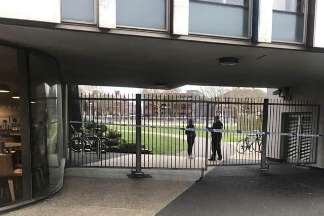 Police at the entrance of Ravelin Park at the University of Portsmouth library in Cambridge Road on March 21. The park has been taped off after an incident. Picture: Harrison Simpson