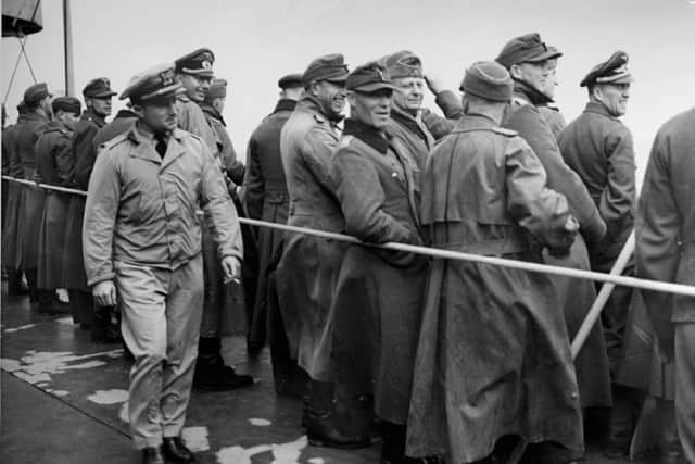 Being an Allied prisoner doesn't seem to be a disagreeable lot for a German soldier these days.  These Nazi Officers and enlisted men, captured in France, laugh and joke among themselves as they line the rail of a Coast Guard manned transport bringing them to the safety of an internment camp in the United States.  Coast Guard Lieut. RJ Campbell, Jr keeps an eye on them.