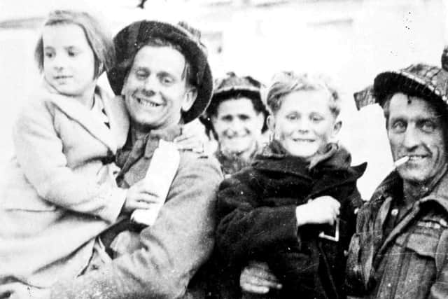 Men of the Hampshires in Arromanches on DDay.  The children are Jean Groudin and Odette Cheviot