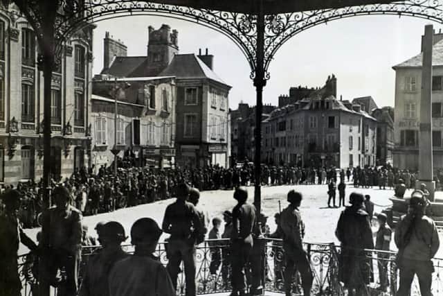 Citizens of Cherbourg, France join American troops in Flag presentation ceremonies in the port square.