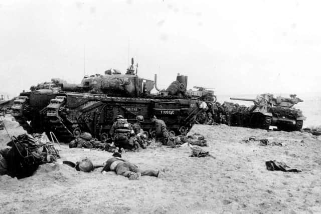 Normandy, France - troops and tanks on a landing beach.