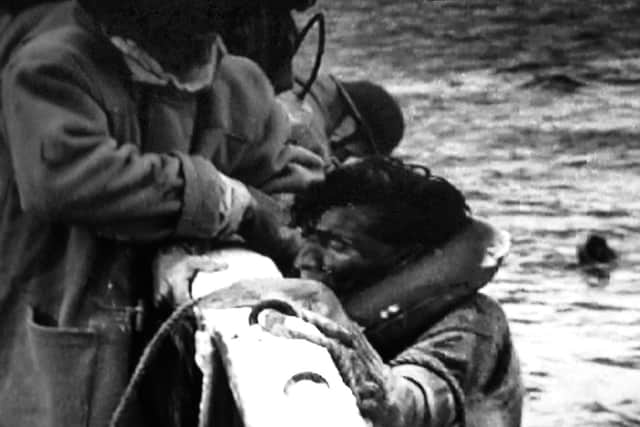 Gordon Walwyn is helped with other survivors' from the boarding nets onto the Saltash Castle. Picture: Courtesy of STUDIONCANAL Films Ltd.