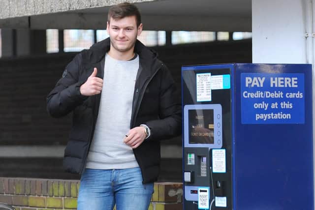 Ben Ager paying for his family's parking after he appeared at Portsmouth Magistrates' Court with his mother and father Deborah and Terry Ager, along with his aunt Joanne Tucker after they all used two counterfeit disabled badges to park in Portsmouth in August Picture: (190319-3026)
