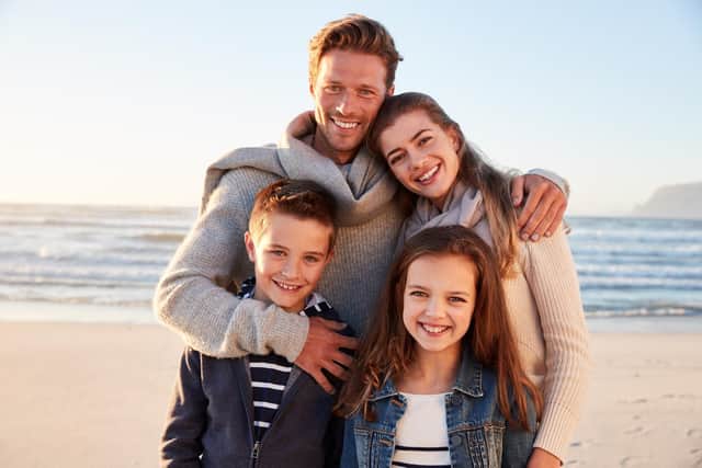 They may look happy but they probably paid an absolute fortune to go on that beach vacation during the school holidays