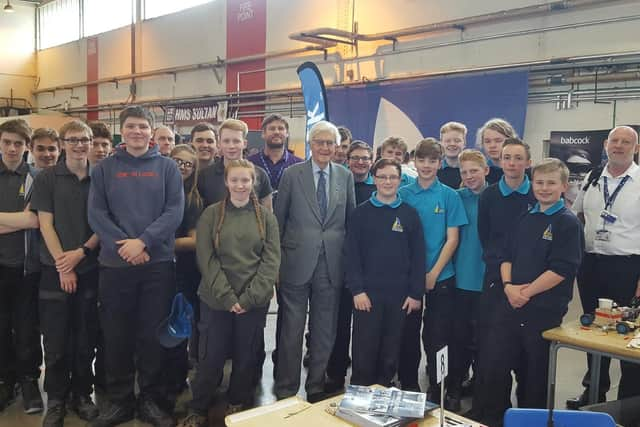 UTC Portsmouth students with Lord Baker (centre). (L-r) Jake Boulton, Samuel Bowers, Joseph Callaghan, Thomas Challen, Theo Deasy, Ethan Hards, Oliver Hawkins, Oliver Lambert, Robyn Moore, Joseph Rickman, Mollie Smyth, Hugh Westmore. 
The Engineering Teaching Staff are Richard Clegg, Gary Hunt, Sean Archibald. 
Royal Navy liason officer: WO1 Stuart Clayton (far right).