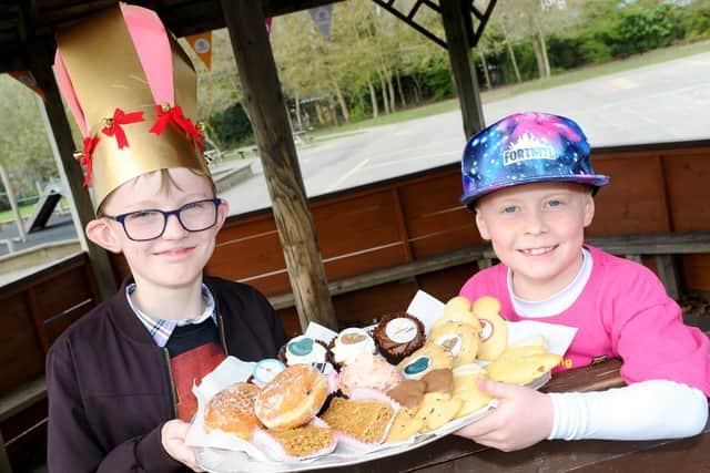 (l-r) Sean Hyslop (8) and Lucas Banks (9) with just some of the cakes which were on offer at the cake sale.

Picture: Sarah Standing (280319-4341)