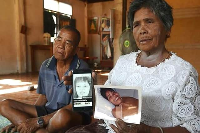 Jumsri Seekanya, with her husband, Buasa, by her side, on January 25 shows a picture of her missing daughter, Lamduan, in her left hand and a sketch of the then-unidentified woman whose body was found in Yorkshire. Picture: Bangkok Post