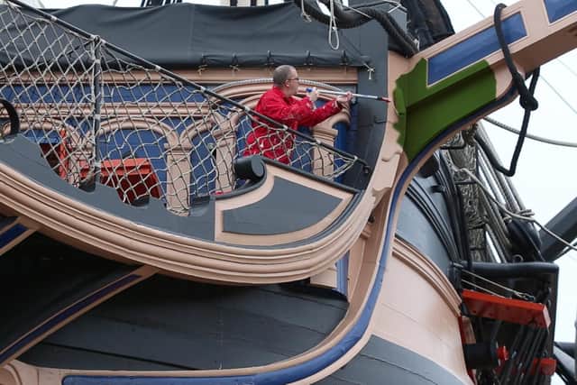 Historic Ships painter Dave Bishop begins the job of painting Victory green