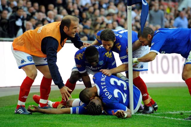 Michael Brown, centre right, joins his Pompey team-mates in mobbing Fredrique Piquionne following his FA Cup semi-final goal against Spurs Picture: Allan Hutchings