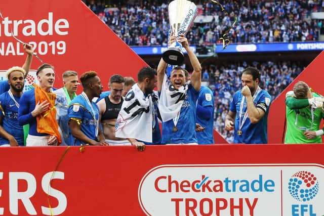 Lee Brown lifts the Checkatrade Trophy following Pompey's triumph. Picture: Joe Pepler