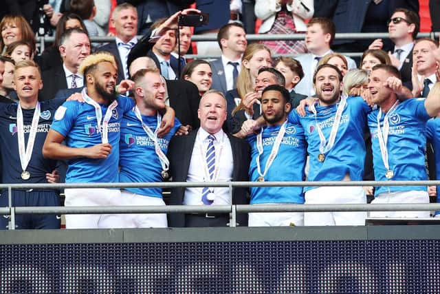 Kenny Jackett, centre, celebrates Pompey's Checkatrade Trophy triumph with his player. Picture: Joe Pepler