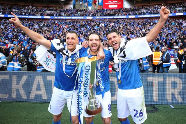 Man of the match Gareth Evans (far right) celebrates Pompey's Checkatrade Trophy triumph with Lee Brown and Brett Pitman.