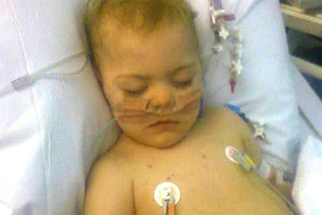 Travis Atkins in hospital aged two