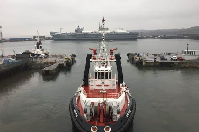 An exterior view of the gap HMS Queen Elizabeth had to fit through to get into Rosyth Dockyard, with HMS Prince of Wales in the distance. Picture: @HMSQNLZ on Twitter
