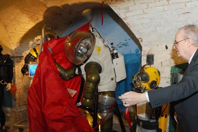 Museum volunteer Richard Castle unveils the Jim suit.
Picture: Sarah Standing (050419-5663)