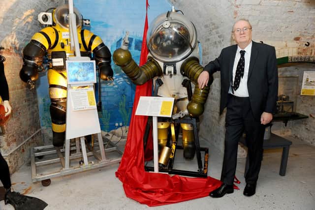 Museum volunteer Richard Castle with the Jim suit.
Picture: Sarah Standing (050419-5669)