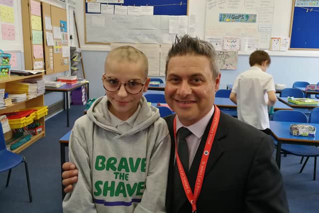 Fiorella Caraccio, 11, had her head shaved by head teacher, Mr Lyndon Strong, to raise money for Macmillon Cancer Support charity.