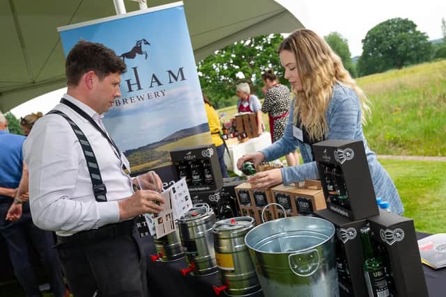 Jess Spreadbury from Upham Brewery serving up a taster to a guest at the launch of the 18th annual Hampshire Food Festival, run by Hampshire Fare. Picture: The Electric Eye Photography