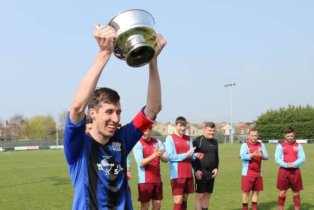 Lovedean captain Darren Smith lifts the Junior C Cup. Picture: Kevin Shipp