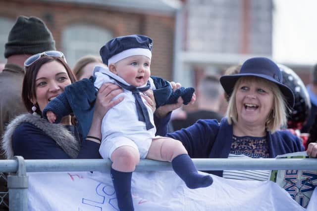 A baby waiting his father to arrive as HMS Dragon returns to Portsmouth. Picture: Habibur Rahman