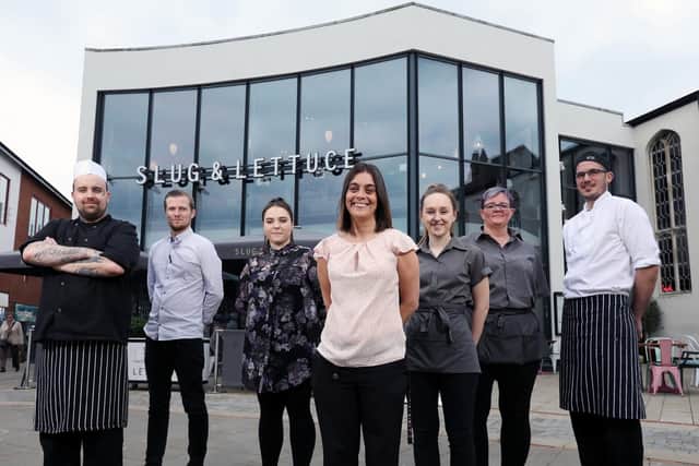 Staff, from left, Kyle Gray, Zac Dudley, Courntey Bowles, general manager Sarah Cook, Charlotte Chatwood, Jaime Young and Mark Reakes at Slug and Lettuce, Fareham. Picture: Chris Moorhouse (120419-29)