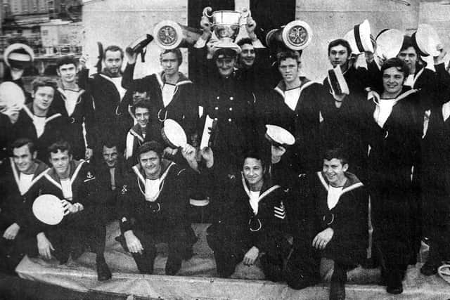 HMS Falmouths gunnery crew who claimed the title Sharpshooters of the Fleet in 1972. CPO Les Storr, of Copnor, holds the trophy.