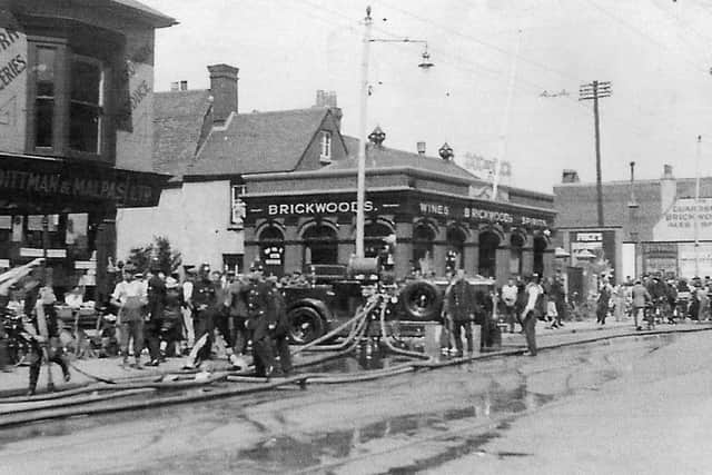 On July 20, 1934, the Co-op in Fratton Road, Portsmouth, was destroyed by fire. I believe this picture shows that event.