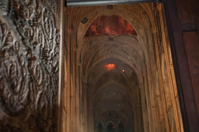 Smoke and flames are seen in the interior of Notre Dame cathedral in Paris. Picture: (Philippe Wojazer/Pool via AP)
