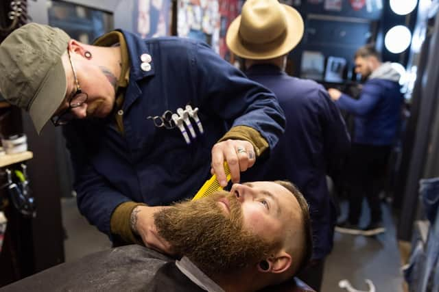 The Barbership is expanding into Hillfield Trading and will have nine seats for hair cutting - Regular customer Colin Hodson enjoys a hair cut and beard trim.
Picture: Duncan Shepherd